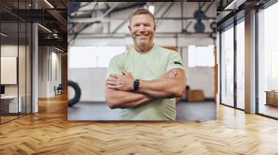 Fitness, sports and portrait of man in gym with crossed arms for motivation, wellness and cardio workout. Personal trainer, healthy body and face of male for bodybuilder training, exercise and goals Wall mural