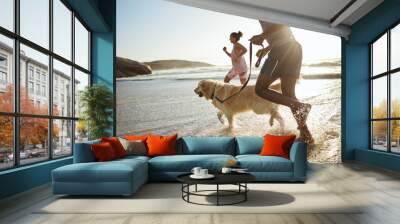 Running, dog and beach with a black couple and pet in the water while on holiday or vacation by the coast. Sand, travel and animal with a man, woman and canine in the ocean or sea during summer Wall mural