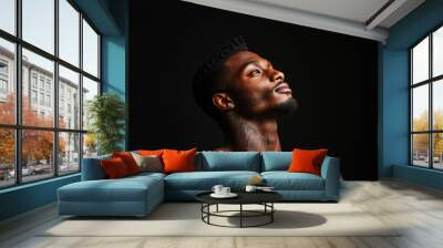 African American man has tattoos on his body on black background. Wall mural