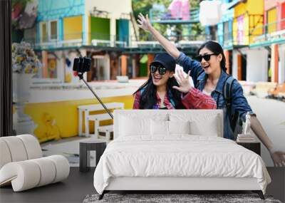 Beautiful girls are traveling abroad with fun. Wall mural