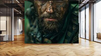 Closeup of a soldier camouflaged with mud on his face in the rain. Wall mural