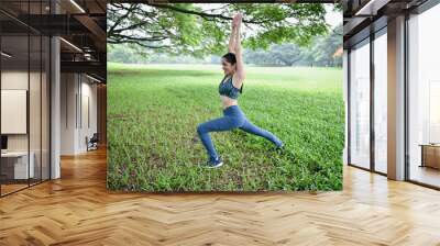 Exercise concept. Beautiful girl is stretching her muscles. Beautiful girls are warming up before running. Wall mural