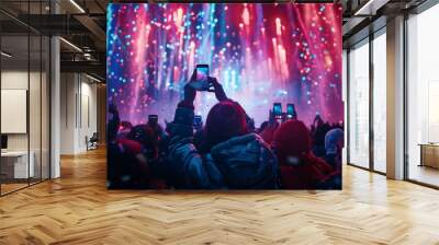 Selective focus of Silhouettes of people holding phones to take pictures at a concert, lights from a performance stage. Wall mural