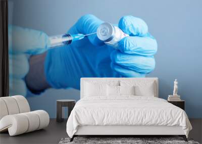 a doctor holding a syringe ready to give a vaccine injection Wall mural