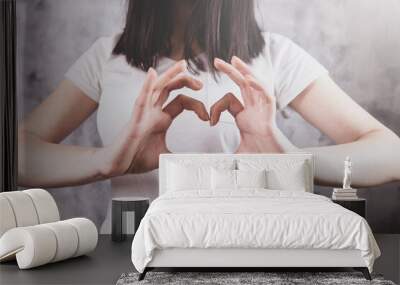 beautiful girl in  makes a heart gesture with her hands Wall mural