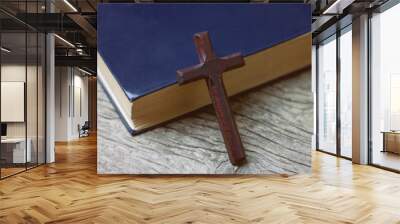 cross with a book on the table Wall mural