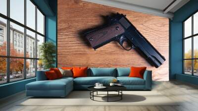 pistol and pistol on a wooden table Wall mural