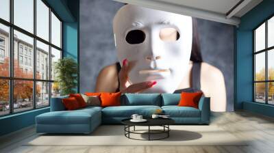 woman holding a plastic mask Wall mural