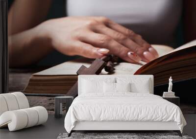 woman praying on book holding cross Wall mural