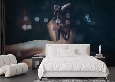 woman praying on book holding cross Wall mural