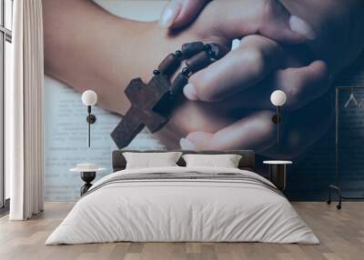 woman praying on book holding cross Wall mural