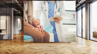 doctor and patient discussing something while sitting at the table . medicine and health care concep Wall mural