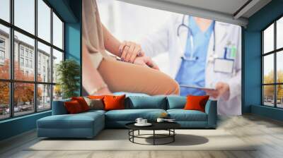 Doctor and patient discussing something while sitting at the table . Medicine and health care concept. Doctor and patient Wall mural