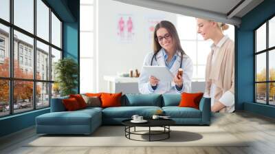 Doctor and patient discussing something while sitting at the table . Medicine and health care concept Wall mural