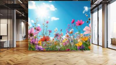 A colorful summer background with a field of wildflowers in full bloom under a bright blue sky, ideal for seasonal graphics with space for messaging. Wall mural