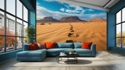 A desert trail with footprints leading off into the distance, capturing the solitude and adventure of hiking in arid conditions with space for copy. Wall mural