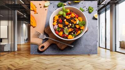 Healthy salad with roasted squash, chickpeas and black lentils, autumn food, vegan eating Wall mural