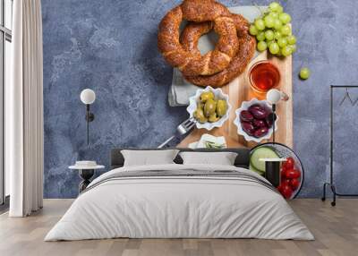 Traditional turkish breakfast with olives, simit bagels, feta cheese, tea, oriental snack on wooden board Wall mural