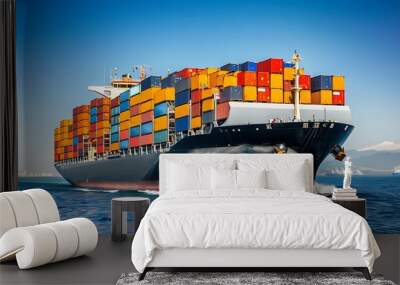 a powerful container ship loaded with colorful shipping containers, representing international transport, cruising across the open sea under a clear blue sky Wall mural