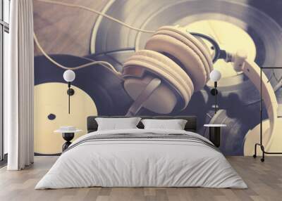 Headphones lying on a vinyl records. Music concept. Wall mural