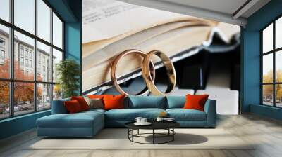 Two wedding rings, a book and a piano Wall mural