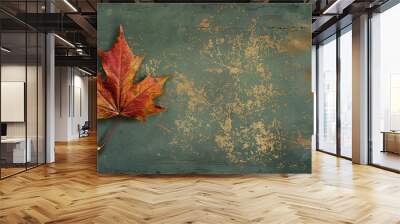 A single brown maple leaf with a textured green background with gold flecks. Wall mural