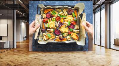 baked carrots, beets, potatoes, zucchini and tomatoes on a baking sheet, top view food Wall mural