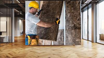 The dry waller is laying a acoustic insulation in to the plasterboard construction. Wall mural