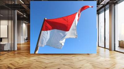 The red and white flag of the Republic of Indonesia is attached to a bamboo stick. Wall mural