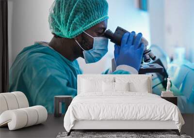 African scentist men with microscope working inside laboratory - Coronavirus outbreak Wall mural