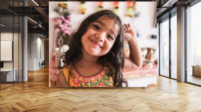 Cute indian girl with traditional dress celebrating religion hindu event at home - Focus on the nose Wall mural