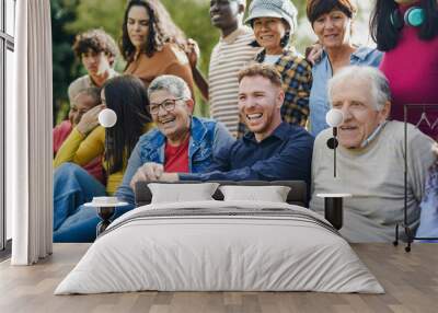 Group of multi generational people having fun together outdoor - Multiracial friends enjoy day at city park Wall mural