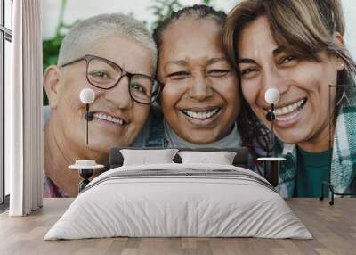 Happy multiracial senior women having fun together outdoor - Elderly generation people hugging each other Wall mural