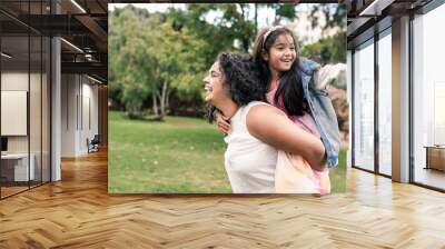 Indian mother and child having playful time at city park - Family love concept Wall mural