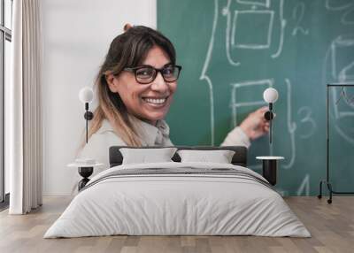 Mature latin female teacher smiling on camera inside classroom - Concept of online class Wall mural