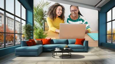 Senior african mother and adult daughter using laptop computer indoor - Family and technology concept Wall mural