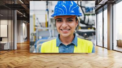 Young latin engineer woman smiling on camera inside robotic factory Wall mural