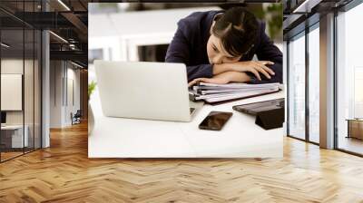 young businesswoman Wearing a suit bending over the table Wall mural