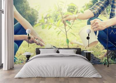 young man and woman plant a tree Wall mural