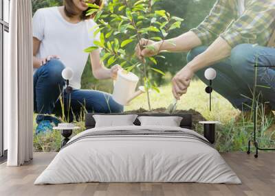 young man and woman plant a tree Wall mural