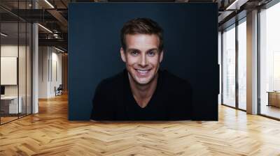 Portrait photo of young happy man with a blinding smile in v nec Wall mural