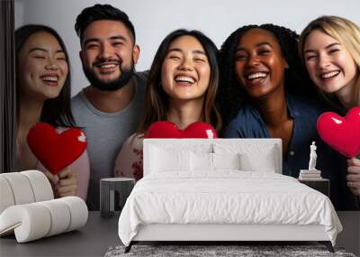 Diverse group of friends smiling and holding heart symbols for friendship and love concept Wall mural