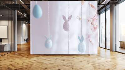 Pastel easter garland with hanging eggs and bunnies for festive decoration Wall mural