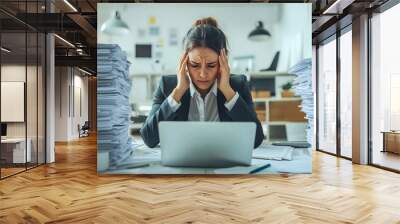 Frustrated woman in a office looking extremely stressed and overwhelmed indicating tension or frustration Wall mural