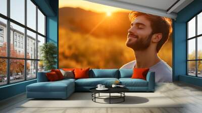 Portrait of a young man taking deep breath fresh air with copy space. Relaxation and well-being concept Wall mural