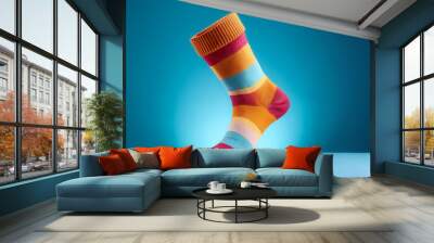 Colorful socks floating or flying isolated on light blue background Wall mural