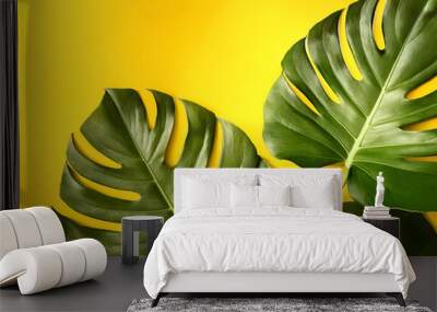 Dragon Tail Monstera or Epipremnum Pinnatum tropical leaves on ligh yellow color background minimal summer Wall mural