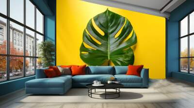 Dragon Tail Monstera or Epipremnum Pinnatum tropical leaves on ligh yellow color background minimal summer Wall mural