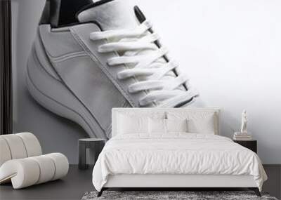 Plain white sneakers with minimalist design isolated on white background Wall mural