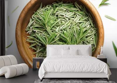 Rosemary in wooden bowl isolated on white background Wall mural